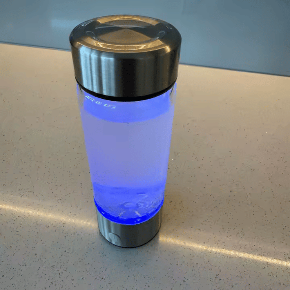 Tumbler with blue light on a speckled countertop