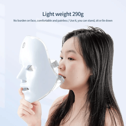 Person holding a white face mask with text about weight and comfort on a light blue background