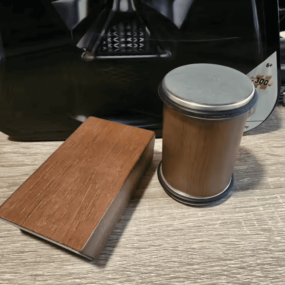 Wooden block and cylindrical object on a textured surface with a blurred background