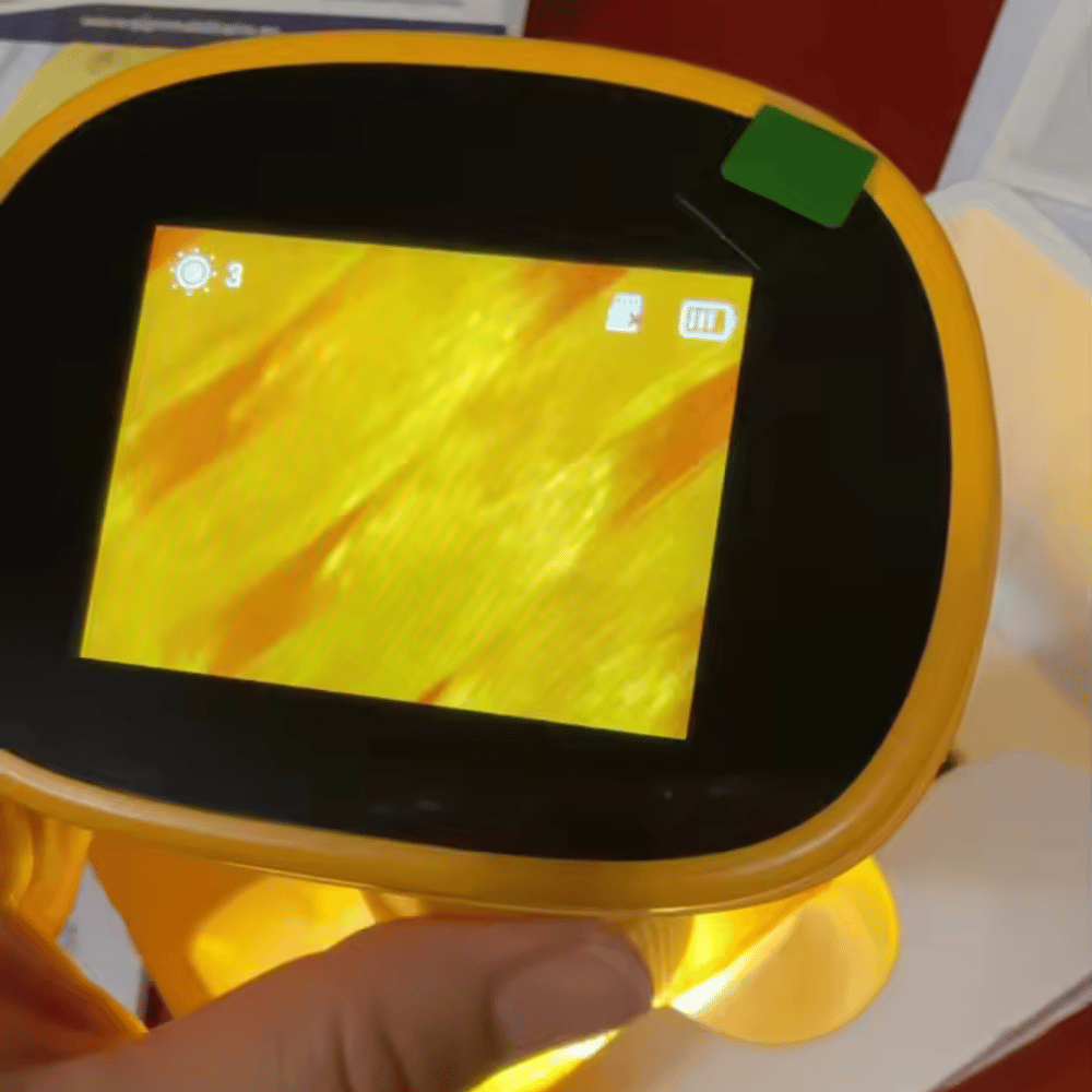 Yellow electronic device with a screen displaying a yellow pattern, held by a hand.