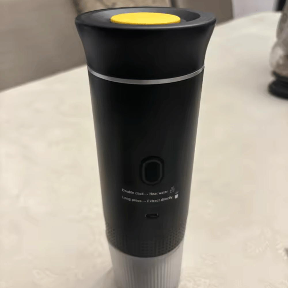 Black and yellow handheld device on a light-colored surface