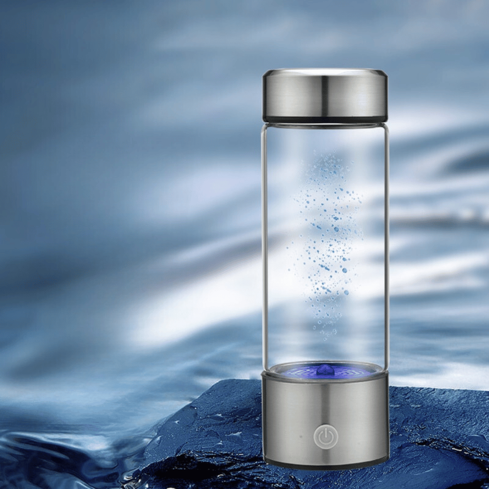 Glass water bottle with silver base and lid on a blue water background